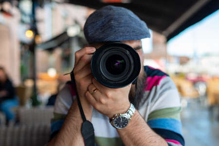 Young man taking photo with his digital camera. Front view.の写真素材
