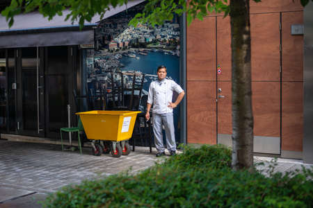 Oslo.Oslo/Norway-09.17.2020: Young chef smoking outside restaurant after hard day at work.のeditorial素材