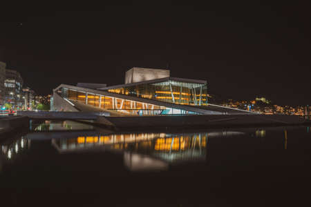 Oslo.Norway-09/18/2020: Architecture near Oslo central station and Karl Johan areas at night. Colorful city lights. Low light photography with long exposure and film grain.のeditorial素材