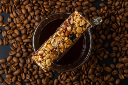 Top view of hot coffee cup and blurred coffee beans.の写真素材