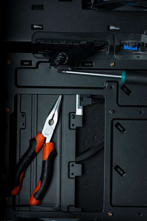 Tools inside Pc case, representing pc building and service. Black background with place for text.の写真素材