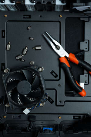 Tools inside Pc case, representing pc building and service. Black background with place for text.の写真素材
