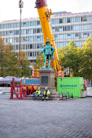Oslo.Oslo/Norway-10.12.2020:  Construction site in Oslo. Workers resting at a lunch break while seagull is relaxing on the head of the sculpture.のeditorial素材