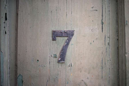 Lucky number seven on a grudge dark wooden wallの写真素材