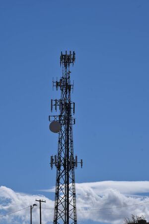 Cell phone tower against a blue skyの写真素材