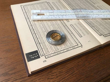 Book of Logarithmic Tables, Slide Rule and a Silver Coin with Abacus