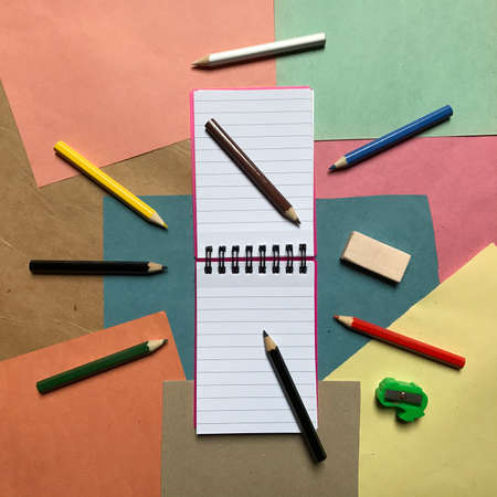 Open Notebook with a Set of Colored Pencils Aroundの写真素材