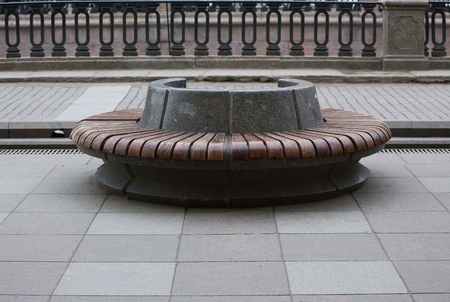 Round granite bench with wood trim