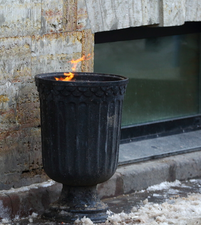 Street urn with burning garbageの写真素材