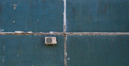 One air conditioner on a blue tiled wallの写真素材