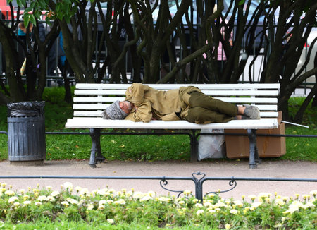 Sleeping on a bench homeless, Nevsky Prospekt Peterburg Russia July 2019のeditorial素材