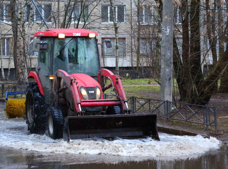 Tractor removes meltwater, ulitsa podvoyskogo, Saint Petersburg, Russia, February 2020のeditorial素材