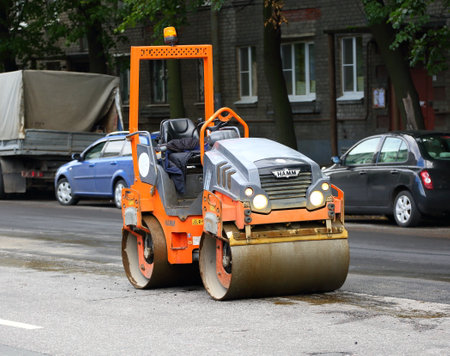 Machine for laying pavement Dvinskaya ulitsa in Saint Petersburg Russia August 2019