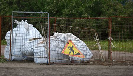 Mesh metal fence with road works sign