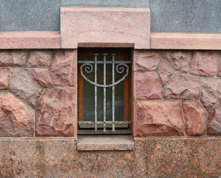 A basement window with a metal barrierの写真素材