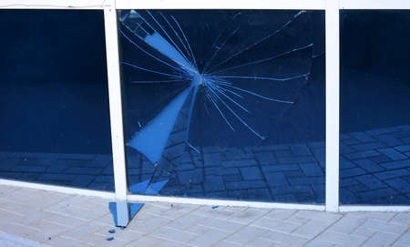 Broken blue glass in a white window frame