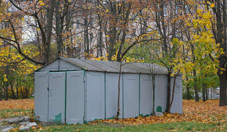 Gray metal shed in the yard in autumnの写真素材