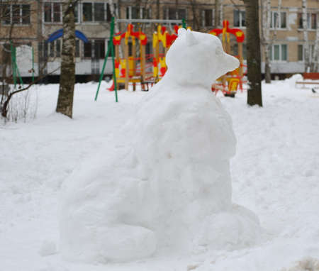 A snow figure in the courtyard of a residential buildingの写真素材