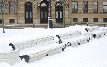 Snow-covered park benches, Admiralteyskaya embankment, St. Petersburg, Russia, January 2022のeditorial素材