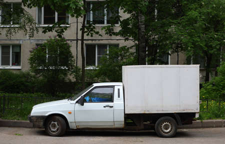 A white passenger car with a body for cargo transportationの写真素材