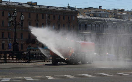 Special equipment refreshes the city street with water on a hot day