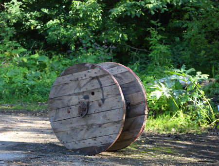 An old cable reel discarded in the forestの写真素材
