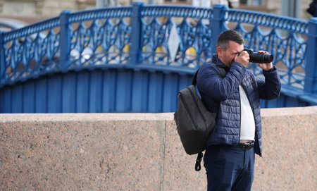 Male photographer on the embankmentの写真素材