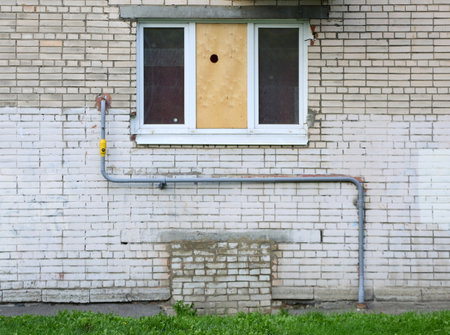 A metal pipe on white brick wallの写真素材
