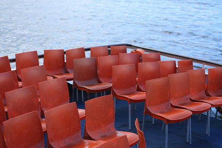 Plastic chairs for passengers at the stern of a pleasure boatの写真素材