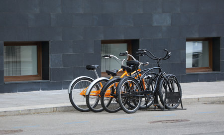 Bicycle parking on the sidewalk near the wall of the house