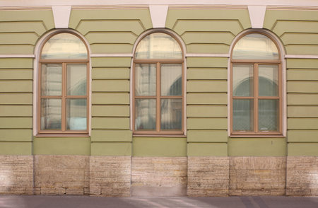 Three arched windows on the ground floor of the house