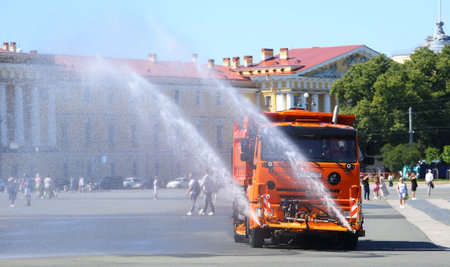 A special machine pours water on the street on a hot summer dayの写真素材