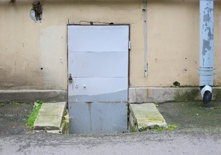 A metal door to the basement with a padlockの写真素材