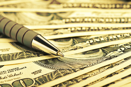 close-up pen on the money with shallow DOFの写真素材