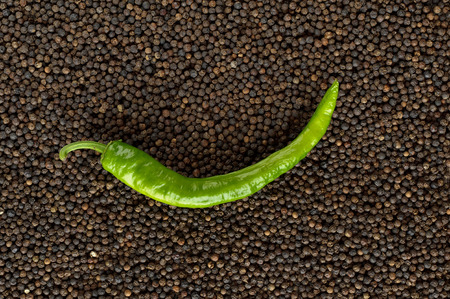 closeup green peppers on black peppercornsの写真素材