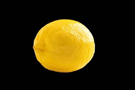 Photo of closeup ripe yellow lemon isolated on black backgroundの写真素材