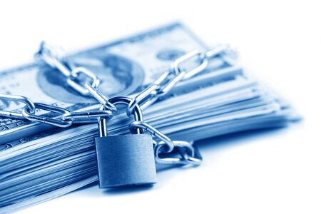 Business safety or financial protection or restriction access. Heap of money in chain with padlock isolated on whiteの写真素材