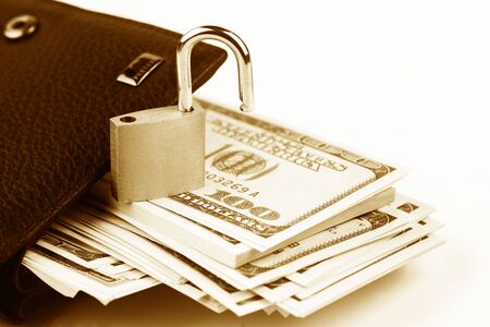 Business safety or financial protection or allow access. Heap of money in chain with open padlock isolated on whiteの写真素材