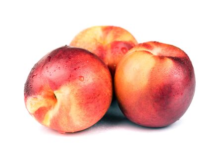 Fresh raw nectarine isolated on whiteの写真素材