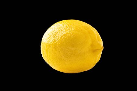 Photo of closeup ripe yellow lemon isolated on black backgroundの写真素材