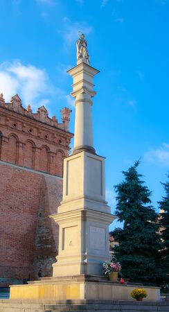 A statue of the Virgin on a high pedestal in front of the town hall in Sandomierz  Polandのeditorial素材