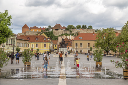 EGER. HUNGARY - JULY 18, 2016: Istvan Dobo Square with a fountain in the foreground and the castle in Eger in the background. Hungaryのeditorial素材