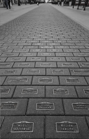LODZ, POLAND - JULY 28, 2016: Monument to the inhabitants of Lodz The Rubezh of the Millennium is almost fourteen thousand concrete slabs with bronze plates on which are written the names of the inhabitants of Lodz, who somehow influenced the history of tの写真素材