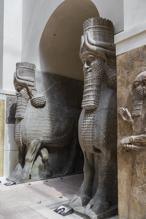 PARIS, FRANCE - MAY 16, 2016: Sculpture of mythical creatures Shedu - Winged Assyrian bulls from Sargon II Palace in Dur Sharruquin. Paris. Franceのeditorial素材