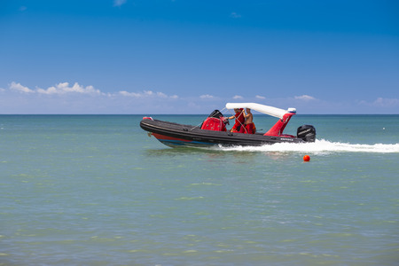 Batumi, Georgia - August 14, 2018: Rescuers patrol the coastline and beach on a motorboat in the scorching sun.のeditorial素材