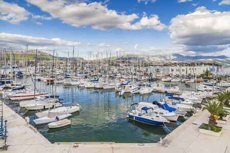 Split, Croatia - Marina with many yachts on the background of picturesque mountains on the horizon and cloudy skyの写真素材