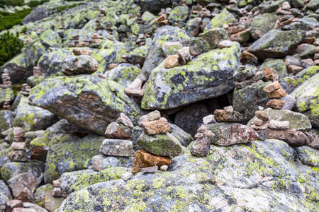 Tower of stones - a Small stone tower of stones set one on top of another, moss and lichens on rocky...