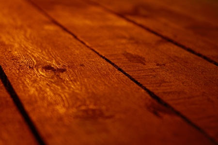Wooden flooring, illuminated by golden artificial light の写真素材
