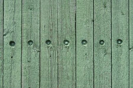 Old decorative fence with hats of nails  の写真素材