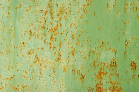 Metal surface with the remains of old green paint 
